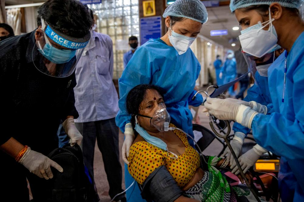 FILE PHOTO: A patient suffering from the coronavirus receives treatment inside the emergency ward at Holy Family hospital in New Delhi, April 29. – Reuters