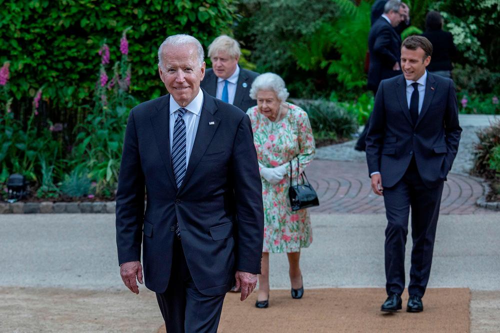 Britain’s Queen Elizabeth, US President Joe Biden, Britain’s Prime Minister Boris Johnson and France’s President Emmanuel Macron attend a drinks reception on the sidelines of the G7 summit in Cornwall, Britain, June 11, 2021. - Reuters