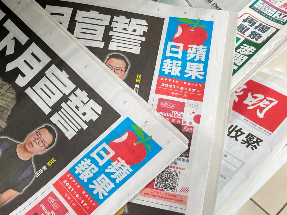Copies of Next Digital’s Apple Daily newspapers are seen at a newsstand in Hong Kong, China June 17, 2021. - Reuters