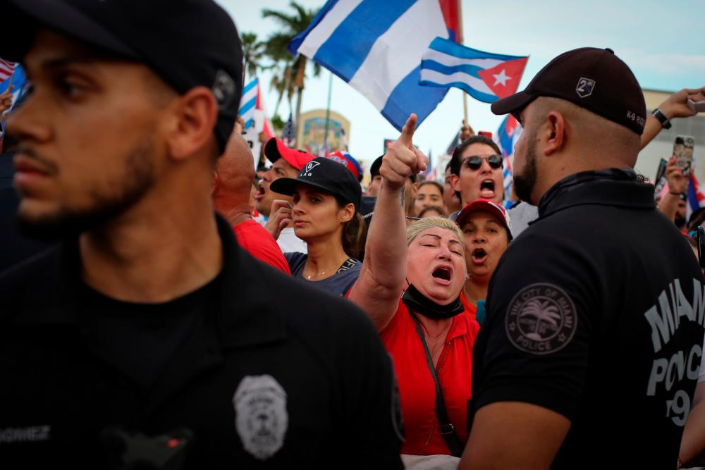 A woman shouts during a rally in solidarity with protesters in Cuba, in Little Havana neighborhood in Miami, Florida, US July 14, 2021. -Reuters