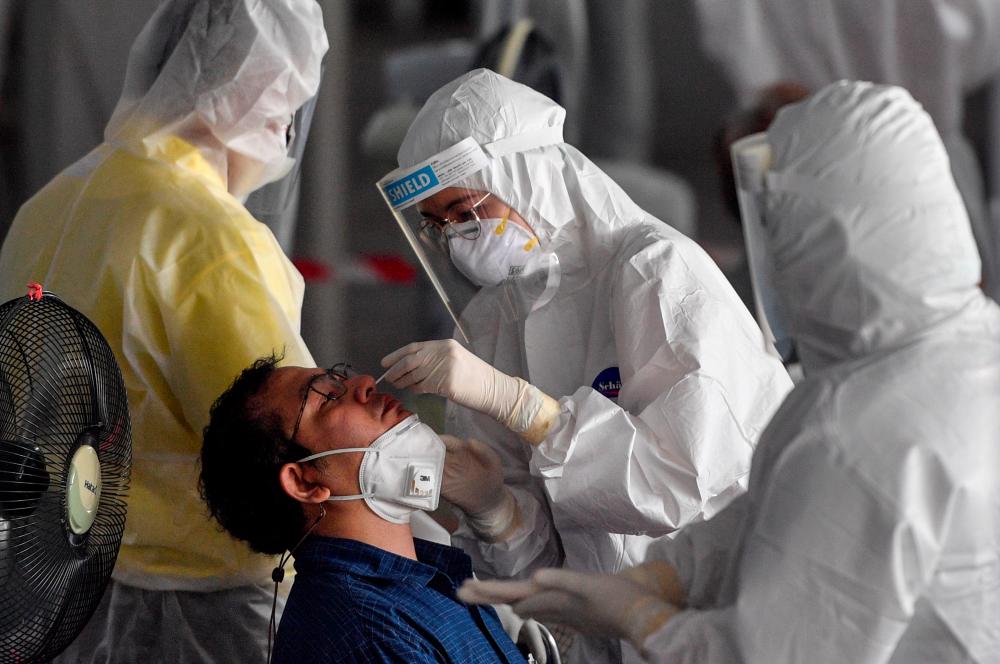 A man undergoes a free coronavirus disease (Covid-19) test at a rapid antigen mass testing station as the spread of Covid-19 continues, in Bangkok, Thailand, July 15, 2021. -Reuters