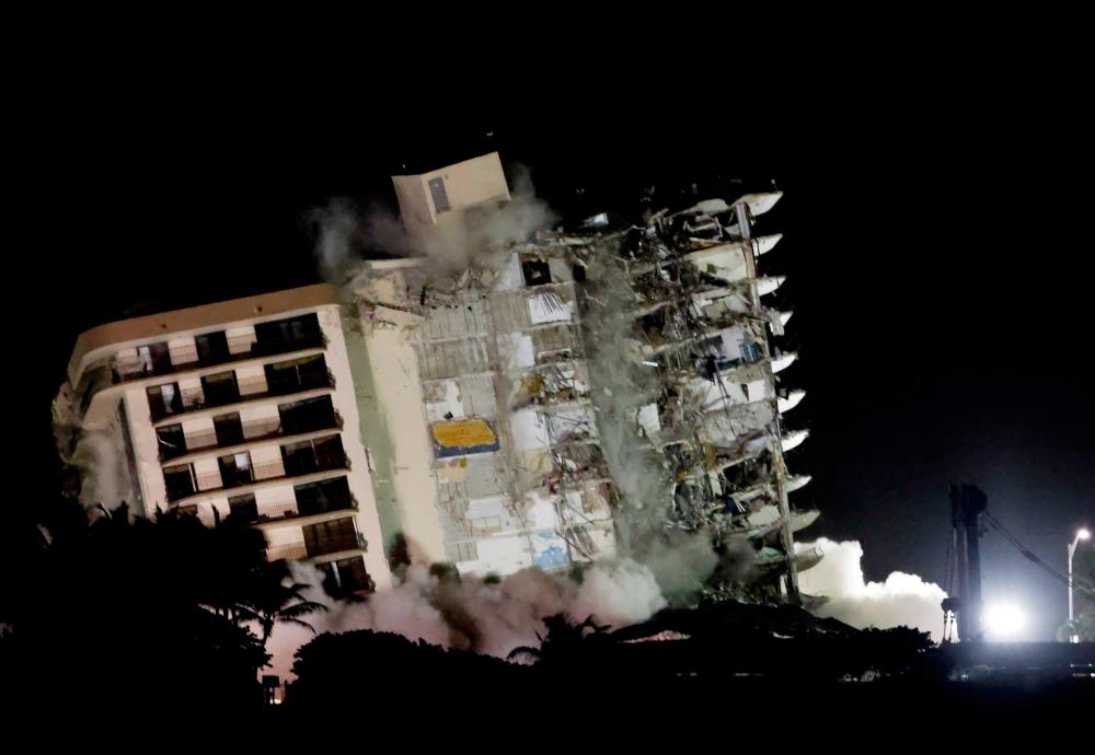 FILE PHOTO: The partially collapsed Champlain Towers South residential building is demolished, in Surfside, Florida, July 4, 2021. -Reuters