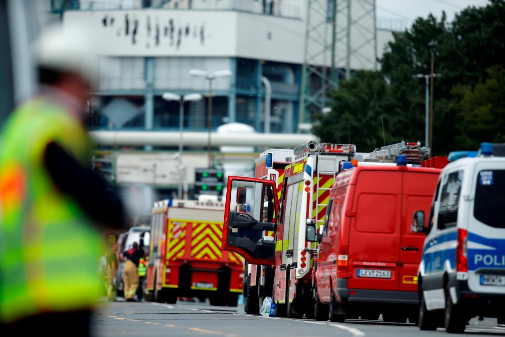 Firefighting trucks and vehicles are seen outside Chempark following an explosion in Leverkusen, Germany, July 27, 2021. - Reuters