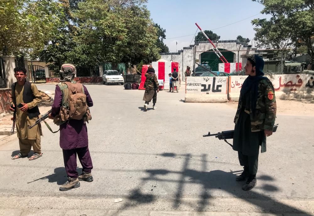 Taliban forces stand guard inside Kabul, Afghanistan August 16, 2021. - REUTERSPIX