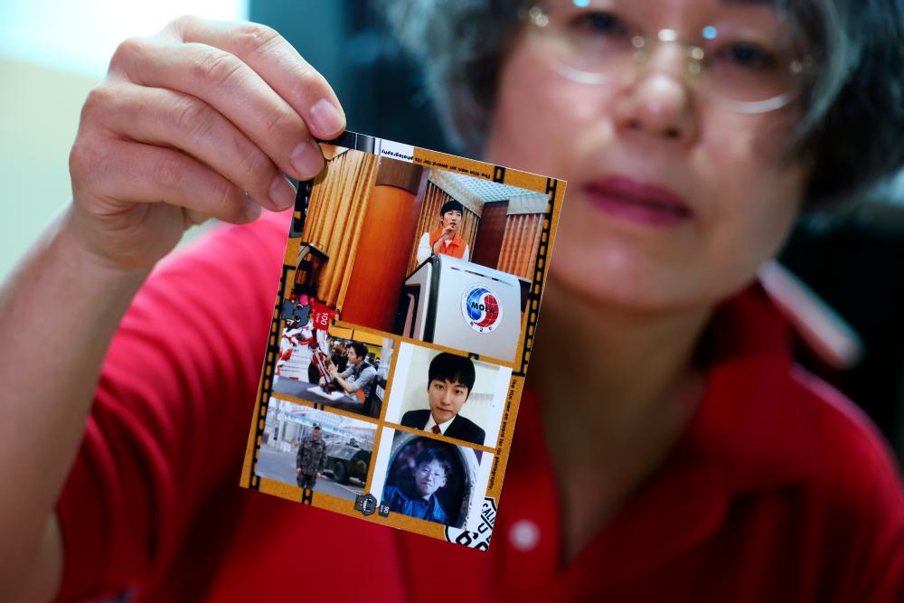 Lee Na-geum whose son Kwon Dae-hee died after undergoing jawline plastic surgery on September 8, 2016, shows her son’s photo during an interview with Reuters at her home in Seoul, South Korea, August 30, 2021. - Reuters