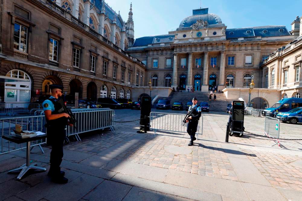 French police stand guard in front of the Paris courthouse on the Ile de la Cite ahead of the opening of the trial of the November 2015 Paris attacks in Paris, France, September 7, 2021. REUTERSpix