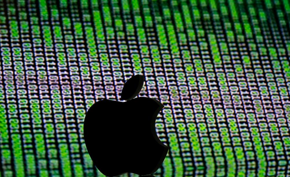 FILE PHOTO: A 3D printed Apple logo is seen in front of a displayed cyber code in this illustration taken March 22, 2016. REUTERSpix