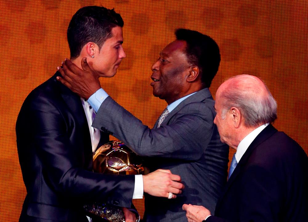 File Photo of Portugal’s Cristiano Ronaldo (left) is congratulated by Pele (centre) after being awarded the FIFA Ballon d’Or 2013 in Zurich. – REUTERSPIX