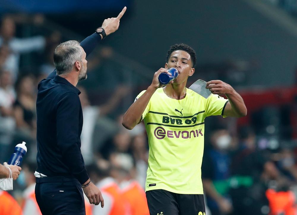 Borussia Dortmund’s Jude Bellingham takes a drink as coach Marco Rose reacts – REUTERSPIX