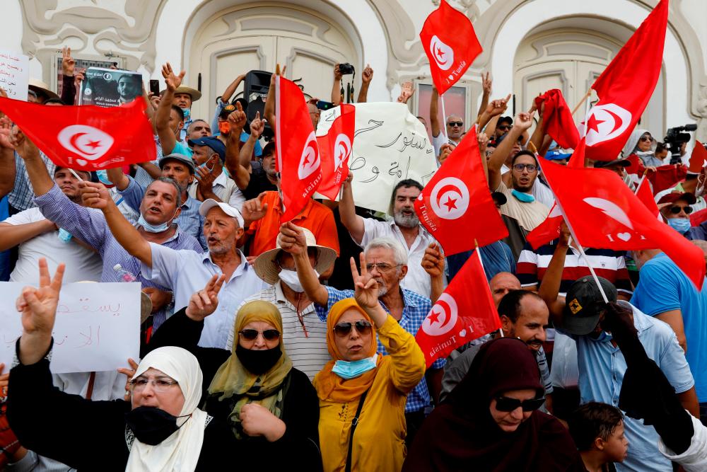 FILE PHOTO: Opponents of Tunisia’s President Kais Saied take part in a protest against what they call his coup on July 25, in Tunis, Tunisia September 18, 2021. REUTERSpix
