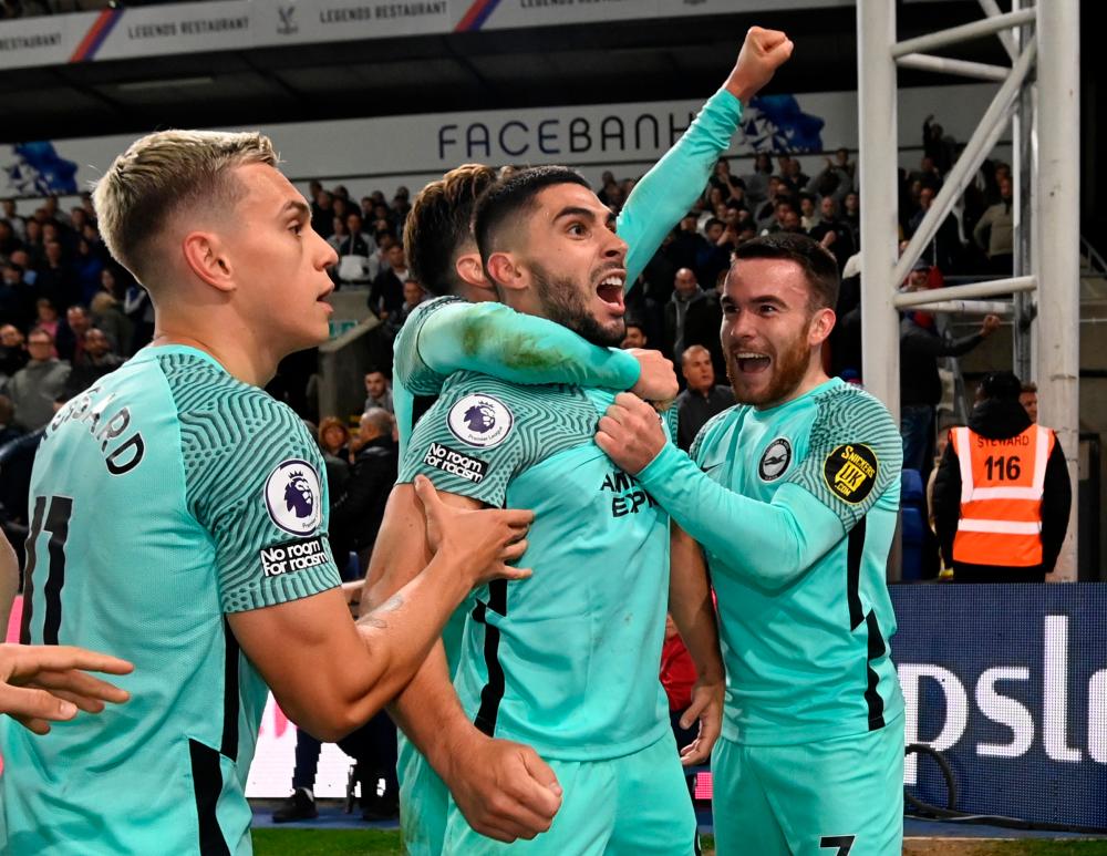Neal Maupay (centre) celebrates scoring their first goal with teammates in Premier League match against Crystal Palace at Selhurst Park, London, Britain. – REUTERSPIX