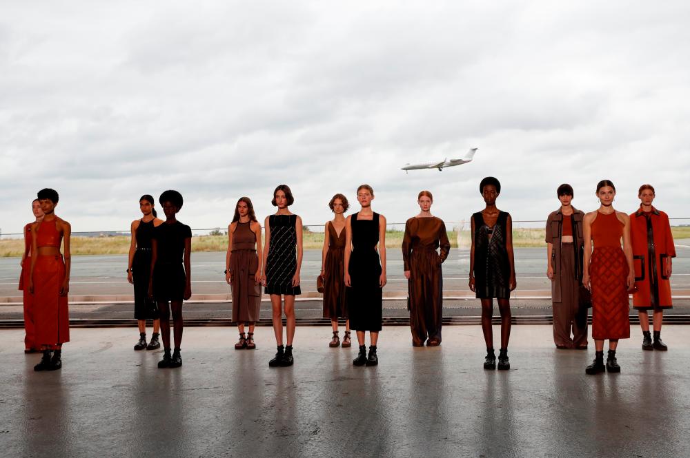 Models present creations by designer Nadege Vanhee-Cybulski as part of a Spring/Summer 2022 women’s ready-to-wear collection show for fashion house Hermes during Paris Fashion Week in Paris, France, October 2, 2021. REUTERSpix