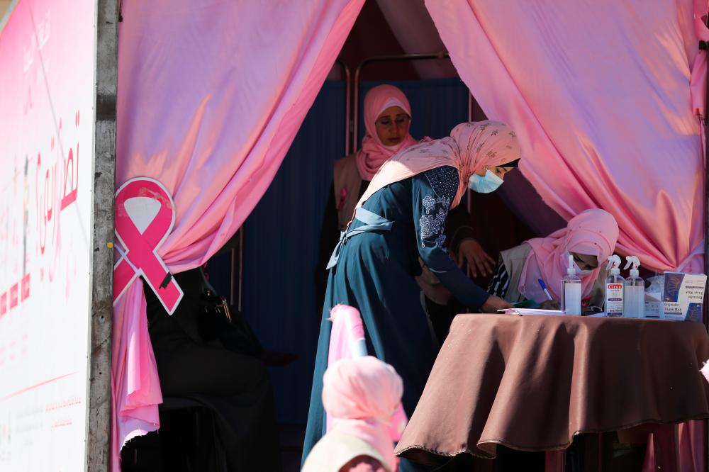 A Palestinian woman registers before a breast cancer check up inside a mobile clinic set up in a truck, during a campaign aimed to raise public awareness in Gaza over the need for early tests to discover breast cancer, in Khan Yunis, in the southern Gaza Strip, October 7, 2021. REUTERSpix