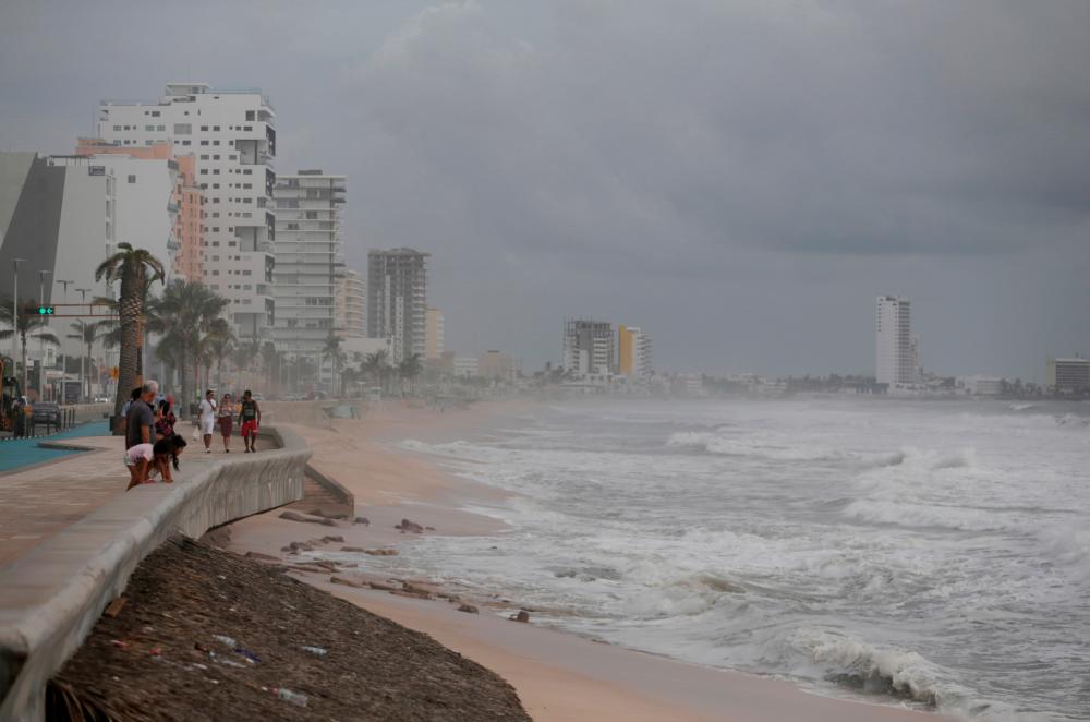 Tourists walk along the Malecon as storm Pamela approaches the Pacific coast resort, in Mazatlan, Mexico, October 12, 2021. REUTERSpix