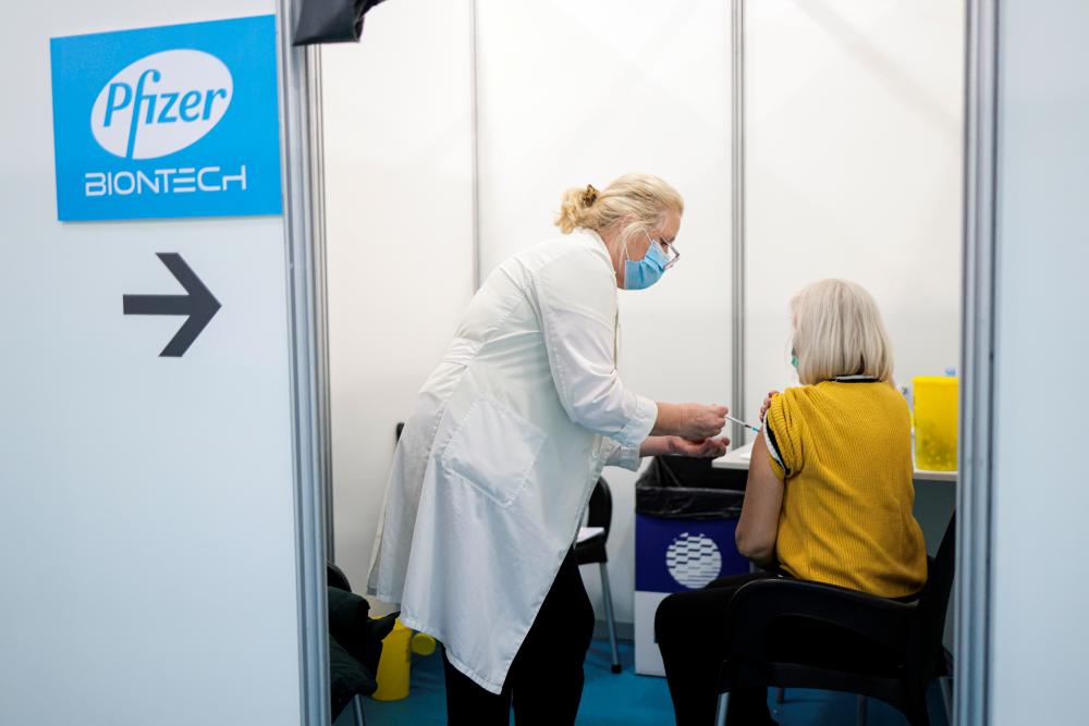 A healthcare worker administers a dose of Pfizer’s coronavirus disease (Covid-19) vaccine to a woman at Belgrade Fair vaccination center in Belgrade, Serbia, October 15, 2021. REUTERSpix