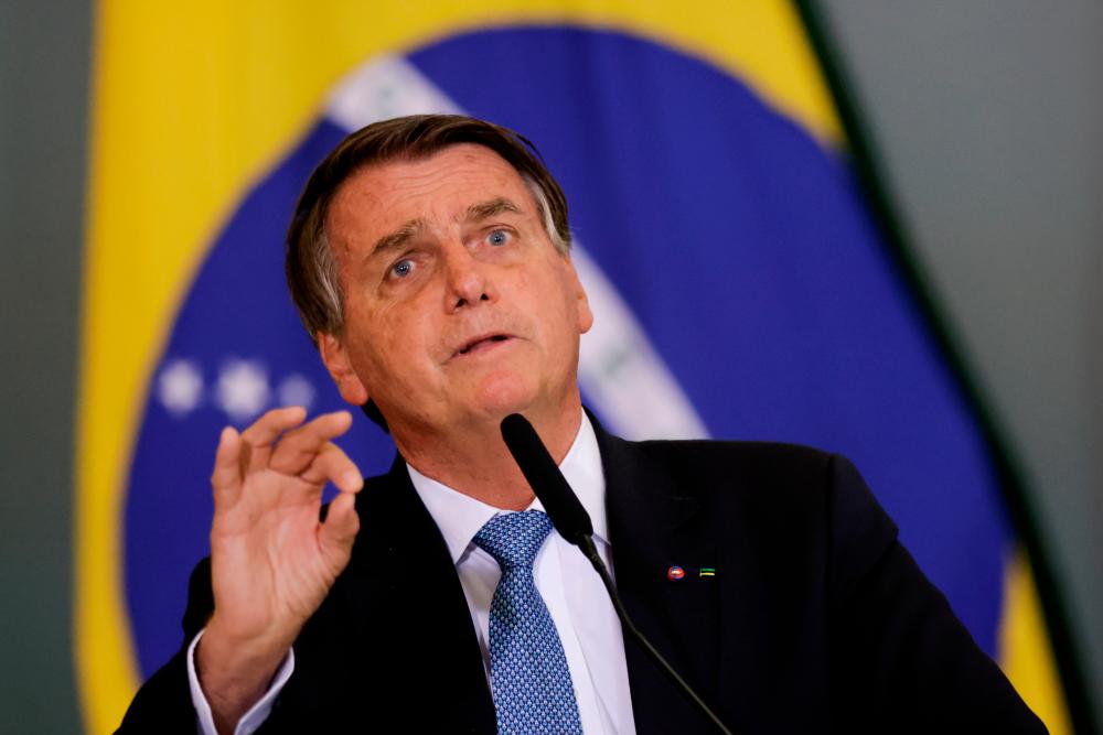 Brazil’s President Jair Bolsonaro gestures during the ceremony for the Modernization of Occupational Health and Safety Regulations, at the Planalto Palace in Brasilia, Brazil October 7, 2021. REUTERSpix