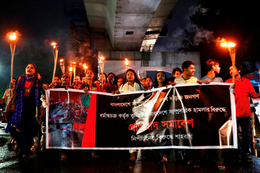Bangladeshi activists join in a torch procession demanding justice for the violence against Hindu communities during Durga Puja festival in Dhaka, Bangladesh, October 18, 2021. REUTERSpix