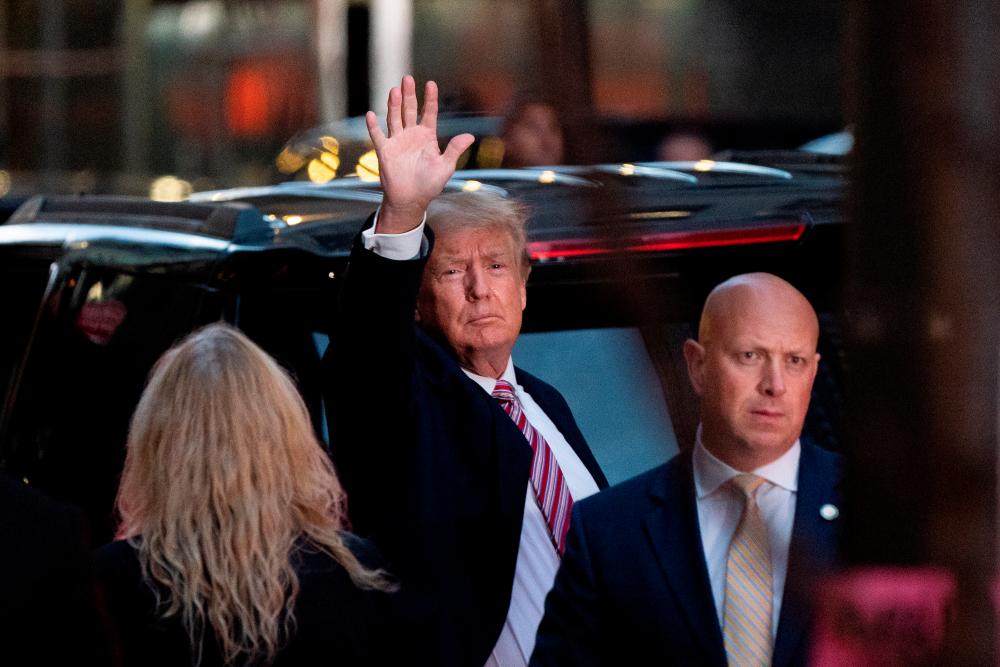 Former US President Donald Trump acknowledges people as he gets in his SUV outside Trump Tower in the Manhattan borough of New York City, New York, US, October 18, 2021. REUTERSpix