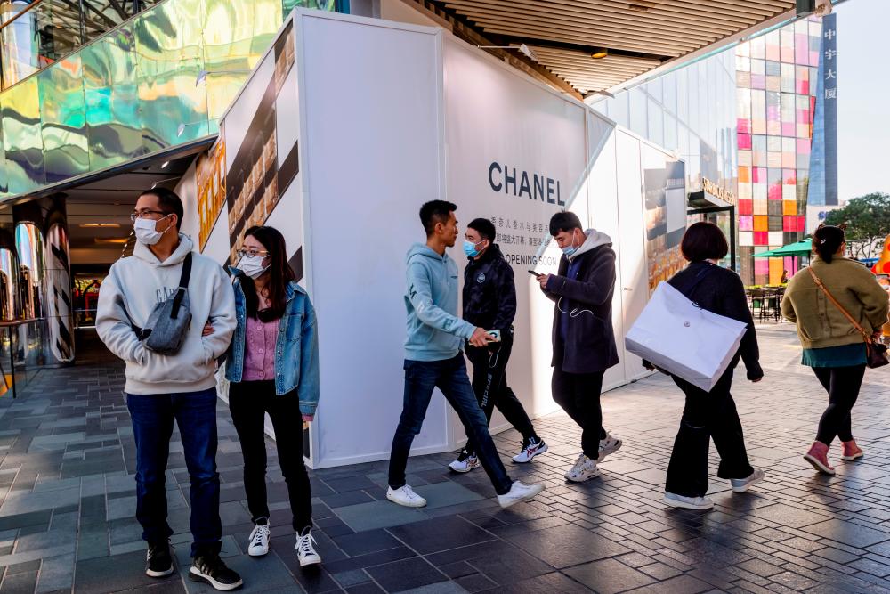 People walk in an upscale shopping district in the Sanlitun area in Beijing, China, October 19, 2021. REUTERSpix
