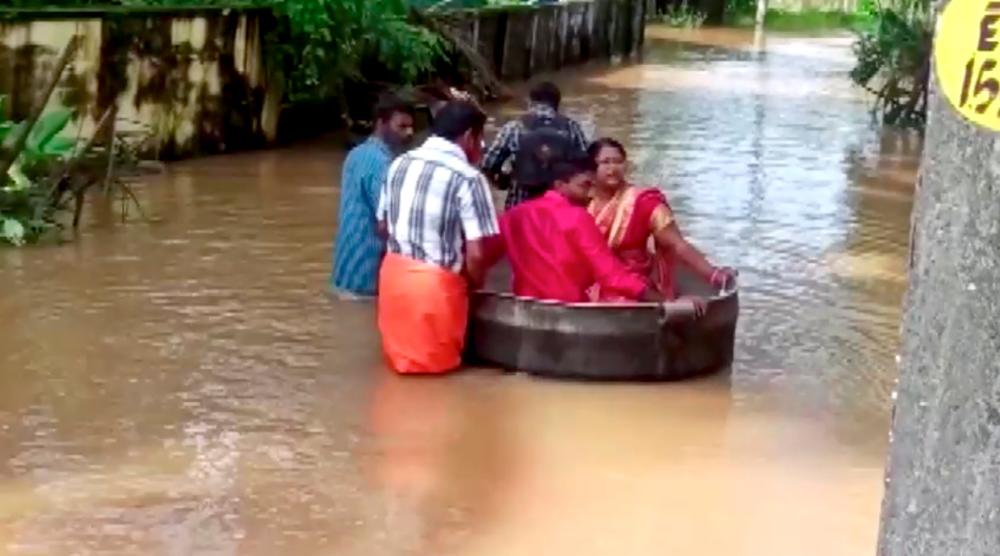 Bride and groom float to a temple in a cooking vessel on a flooded road for their wedding ceremony in this screengrab taken from video, in Alappuzha, Kerala, India, October 18, 2021. AFPpix
