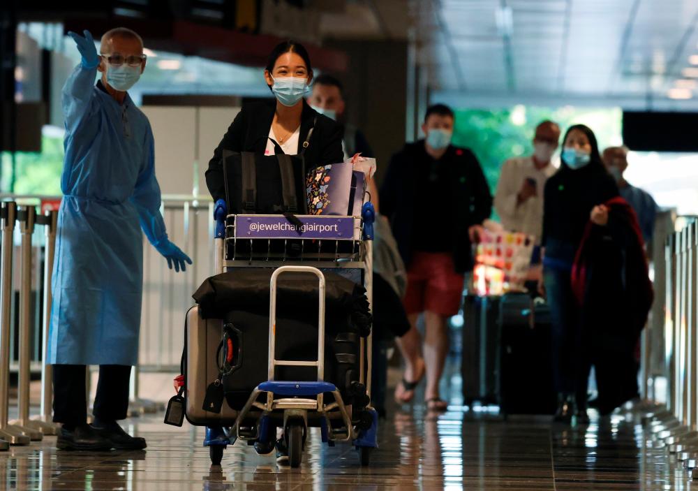 Passengers from Amsterdam arrive at Changi Airport under Singapore’s expanded Vaccinated Travel Lane (VTL) quarantine-free travel scheme as the city-state opens its borders to more countries amidst the coronavirus disease (Covid-19) pandemic, in Singapore October 20, 2021. REUTERSpix