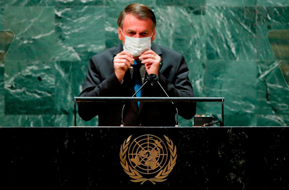 Brazil’s President Jair Bolsonaro puts back on a protective face mask worn due to the coronavirus disease (Covid-19) pandemic after speaking during the 76th Session of the UN General Assembly in New York City, US, September 21, 2021. REUTERSpix