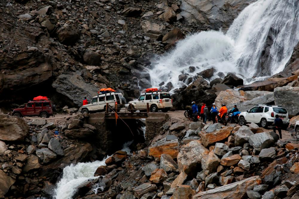 Vehicles get stuck at an area affected by landslide due to bad road conditions after three days of heavy rain at Myagdi, Nepal, October 20, 2021. REUTERSpix