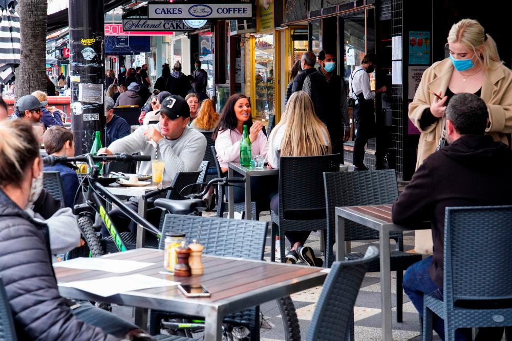 Diners eat outside St Kilda’s Rococo restaurant on the second day of eased coronavirus disease (Covid-19) regulations, following a lockdown to curb an outbreak, in Melbourne, Australia, October 23, 2021. REUTERSpix