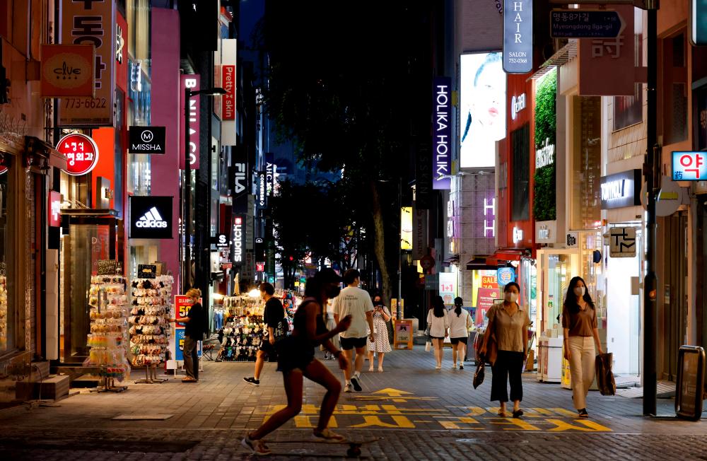 A woman skateboards on a shopping street amid tightened social distancing rules due to the coronavirus disease (Covid-19) pandemic in Seoul, South Korea, July 12, 2021. REUTERSpix