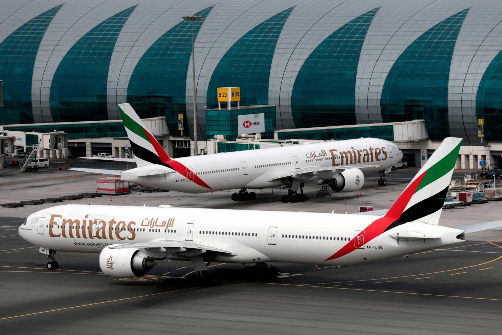 FILE PHOTO: Emirates Airline Boeing 777-300ER planes are seen at Dubai International Airport in Dubai, United Arab Emirates, February 15, 2019. REUTERSpix