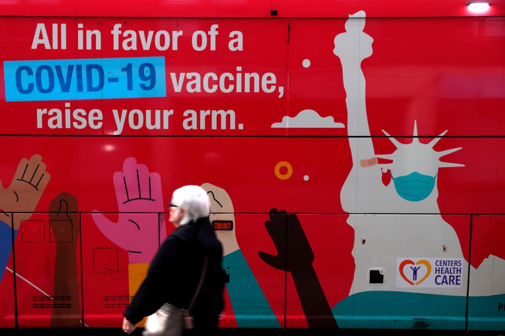 A person walks past a mobile coronavirus disease (COVID-19) vaccine clinic during the spread of the Omicron coronavirus variant in Manhattan, New York, U.S., December 7, 2021. REUTERSpix