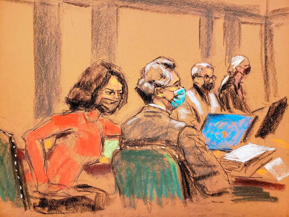 Ghislaine Maxwell passes notes to her defense attorney Jeffrey Pagliuca during the trial of Maxwell, the Jeffrey Epstein associate accused of sex trafficking, in a courtroom sketch in New York City, U.S., December 8, 2021. REUTERSpix