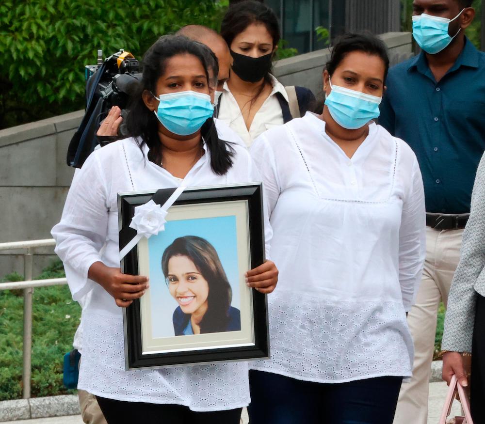 The family of Ratnayake Liyanage Wishma Sandamali who died in March holding her photo heads for Diet Building in Tokyo on May 18, 2021. REUTERSPIX