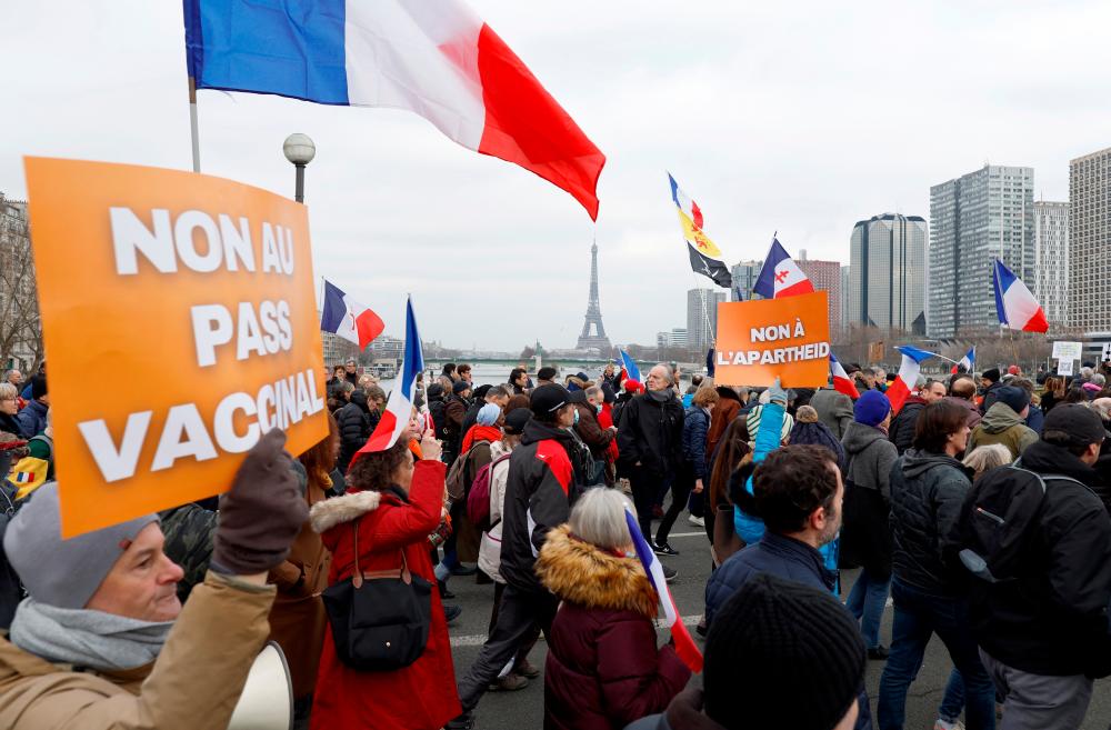 People attend a demonstration called by French nationalist party “Les Patriotes” (The Patriots), to protest against France’s new coronavirus disease (COVID-19) vaccine pass, in Paris, France, January 22, 2022. REUTERSpix