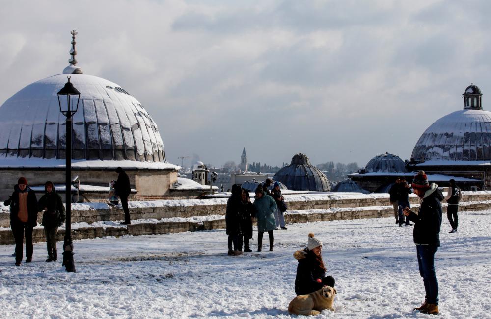 Tourists enjoy a snowy day at the garden of Suleymaniye Mosque in Istanbul, Turkey, January 24, 2022. REUTERSPIX