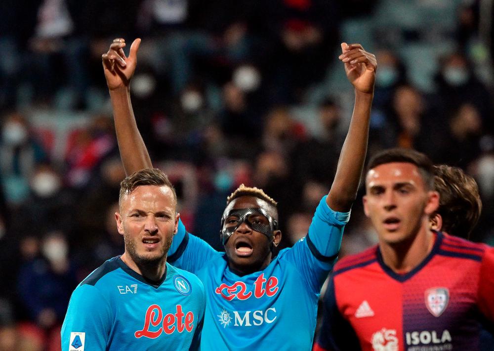 Soccer Football - Serie A - Cagliari v Napoli - Sardegna Arena, Cagliari, Italy - February 21, 2022 Napoli’s Victor Osimhen and Amir Rrahmani REUTERSPIX