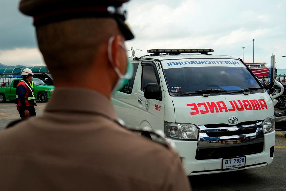 An ambulance carrying the body of Australian cricket player Shane Warne leaves at a ferry port in Koh Samui, Thailand, March 6, 2022. - REUTERSpix