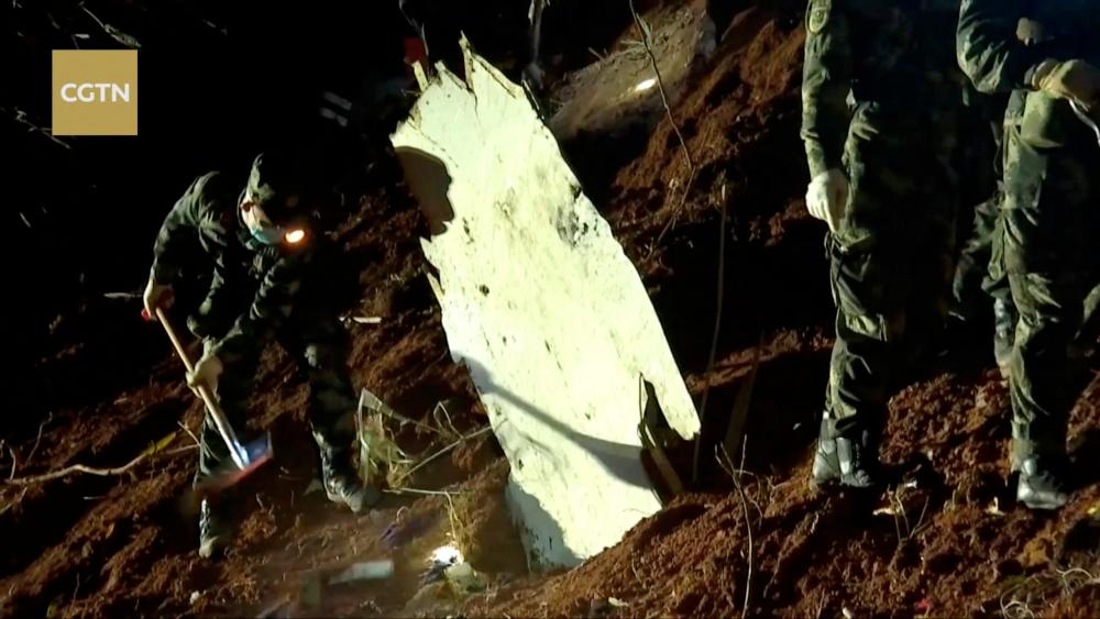 Rescuers work at the site where a China Eastern Airlines Boeing 737-800 plane, flight MU5735, crashed in Wuzhou, Guangxi Zhuang Autonomous Region, China, in this still image taken from a footage March 23, 2022. CGTN via REUTERS TV