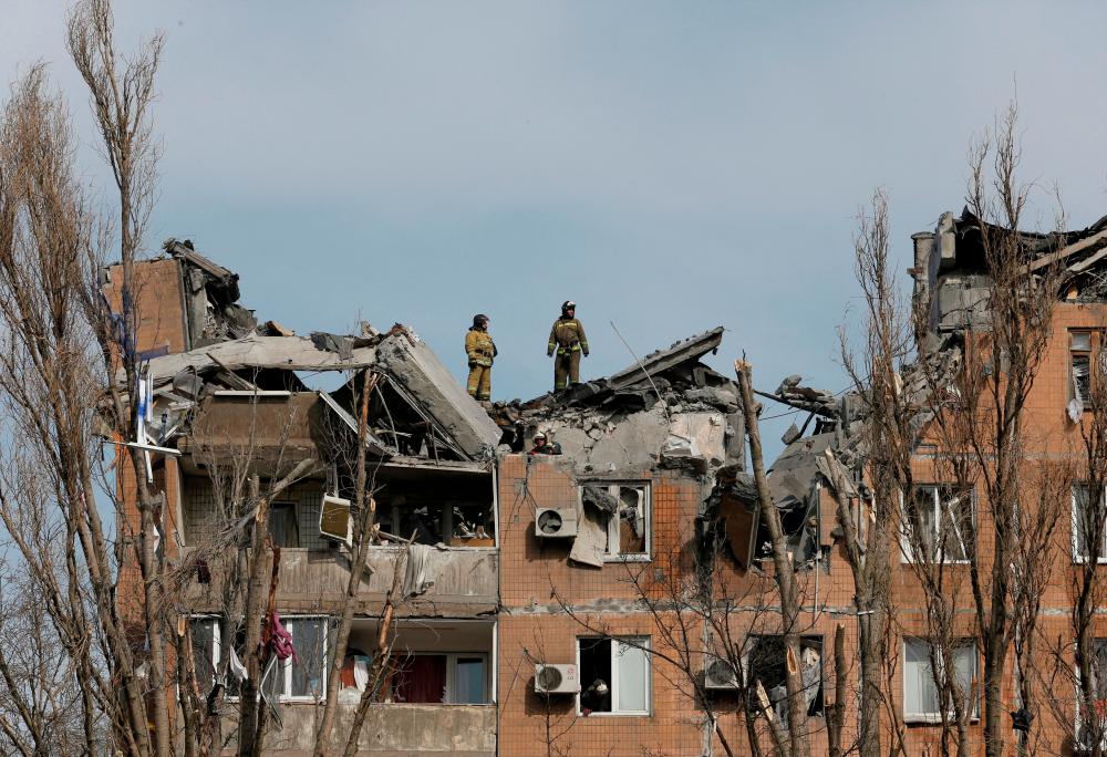 Firefighters work at a residential building damaged by shelling during Ukraine-Russia conflict in the separatist-controlled city of Donetsk, Ukraine March 30, 2022. REUTERSPIX