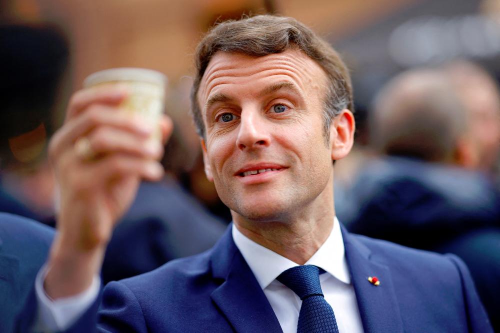French President Emmanuel Macron, candidate for his re-election in the 2022 French presidential election, cheers with supporters during a campaign trip in Spezet, France. Reuterspix