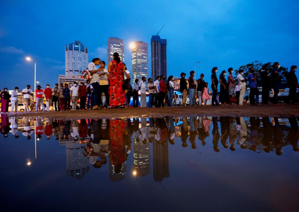 Demonstrators stand in a queue for food in a protest area, dubbed the Gota-Go village, as people gather in opposition to Sri Lanka’s President Gotabaya Rajapaksa near the Presidential Secretariat, amid the country’s economic crisis, in Colombo, Sri Lanka, April 22, 2022. REUTERSpix