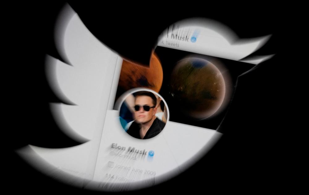 Elon Musk twitter account is seen through Twitter logo in this illustration taken, April 25, 2022. REUTERSPIX