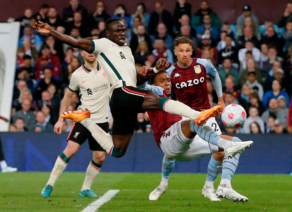 Soccer Football - Premier League - Aston Villa v Liverpool, Villa Park, Birmingham, Britain - May 10, 2022 Liverpool’s Sadio Mane in action with Aston Villa’s Ezri Konsa REUTERSPIX