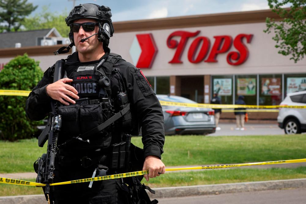 A Buffalo Police officer works at the scene of a shooting at a Tops supermarket in Buffalo, New York, U.S. May 17, 2022. REUTERSPIX