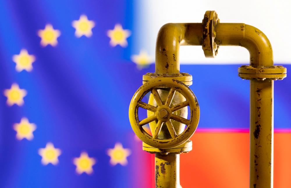 FILE PHOTO: A model of the natural gas pipeline is seen in front of displayed word EU and Russia flag colours in this illustration taken March 8, 2022. REUTERSPIX