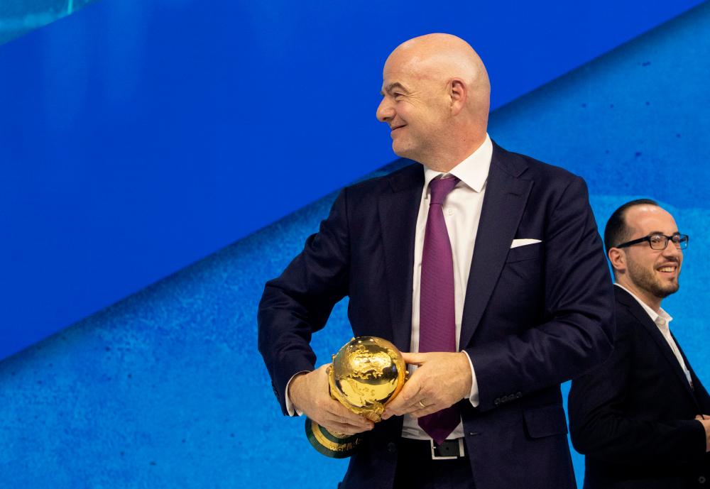 Gianni Infantino, President of FIFA carries the FIFA World Cup trophy after a panel discussion at the World Economic Forum 2022 (WEF) in the Alpine resort of Davos, Switzerland May 23, 2022. REUTERSPIX