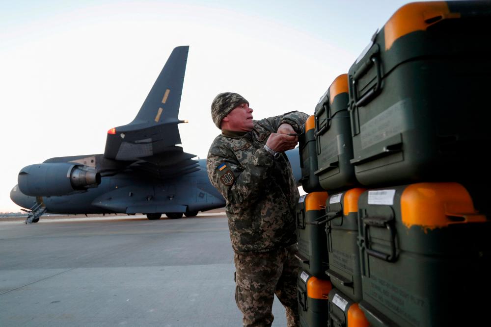 FILE PHOTO: A Ukrainian service member unloads Lithuania’s military aid including Stinger anti-aircraft missiles, delivered as part of the security support package for Ukraine by a 17 Globemaster III plane, at the Boryspil International Airport outside Kyiv, Ukraine, February 13, 2022. REUTERSpix