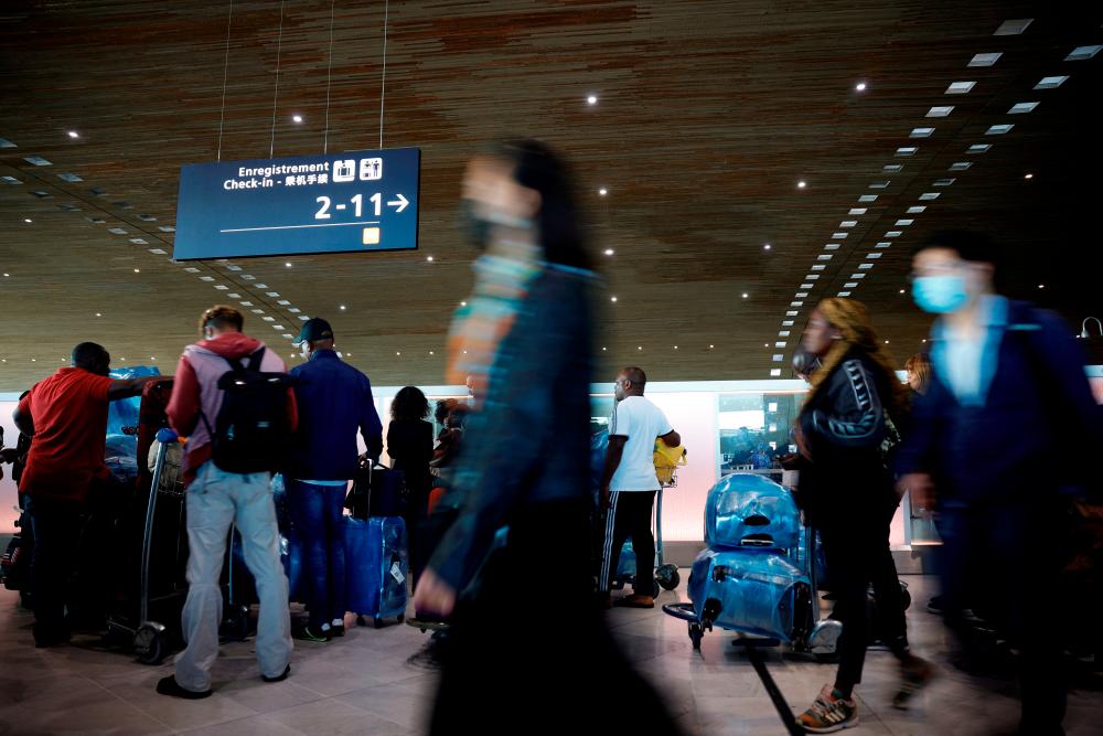 Passengers walk in the departures area of the Terminal 2E at the Paris-Charles de Gaulle airport in Roissy near Paris as French airport workers called for a strike to protest against low wages as inflation hits France, July 1, 2022. REUTERSPIX