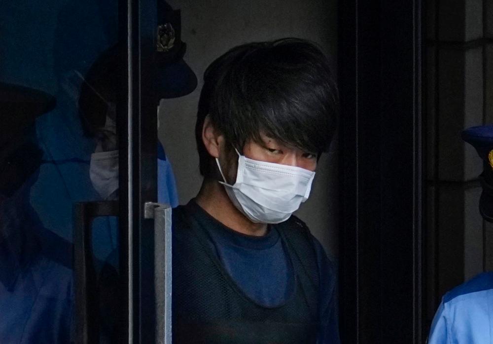 Tetsuya Yamagami, Suspected of killing former Japanese premier Shinzo Abe, is escorted by a police officer as he is taken to prosecutors, at Nara-nishi police station in Nara, western Japan, in this photo taken by Kyodo July 10, 2022. REUTERSPIX