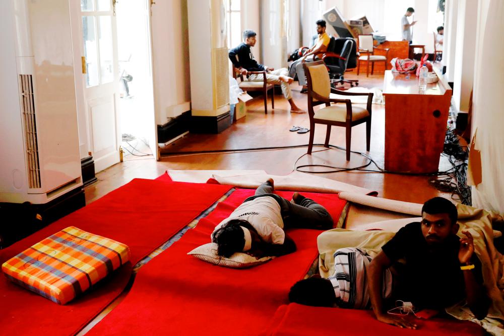 People rest inside the President’s house after President Gotabaya Rajapaksa fled, amid the country’s economic crisis, in Colombo, Sri Lanka July 13, 2022/REUTERSPix